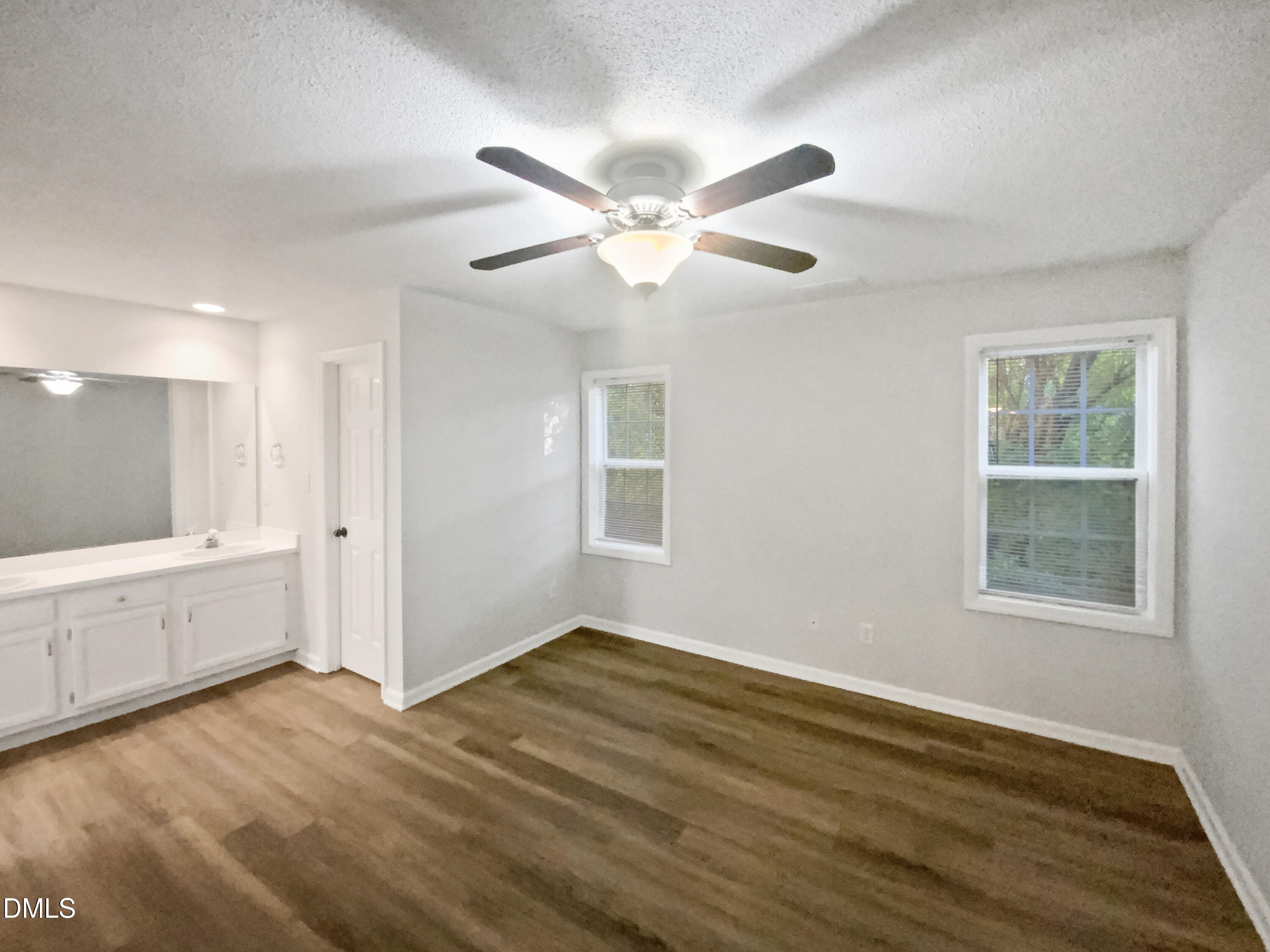 2201 Mountain Mist Court, Unit 103 Raleigh, NC 27603 - Photo 10 of 19 a view of an empty room with window and wooden floor