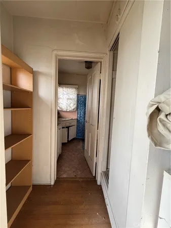 a view of hallway with wooden floor and fireplace