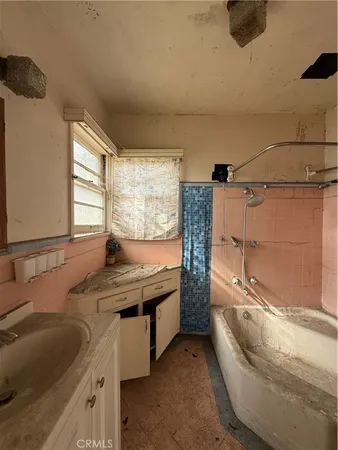 a view of a hallway with wooden floor and a cabinet