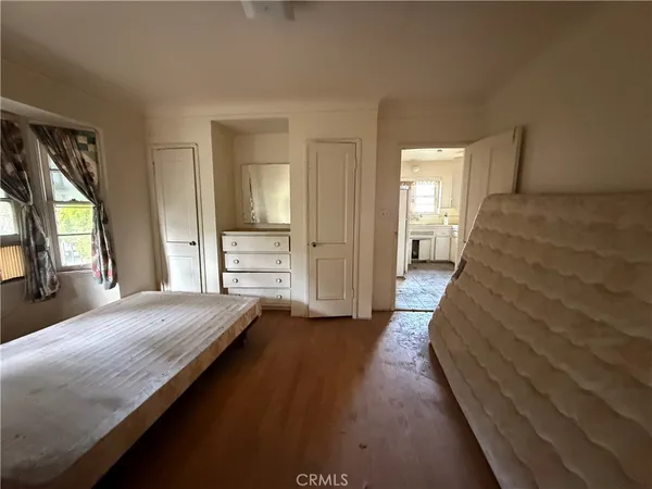 a kitchen with a stove a refrigerator and white cabinets