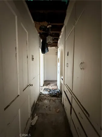 a view of a hallway with wooden walls