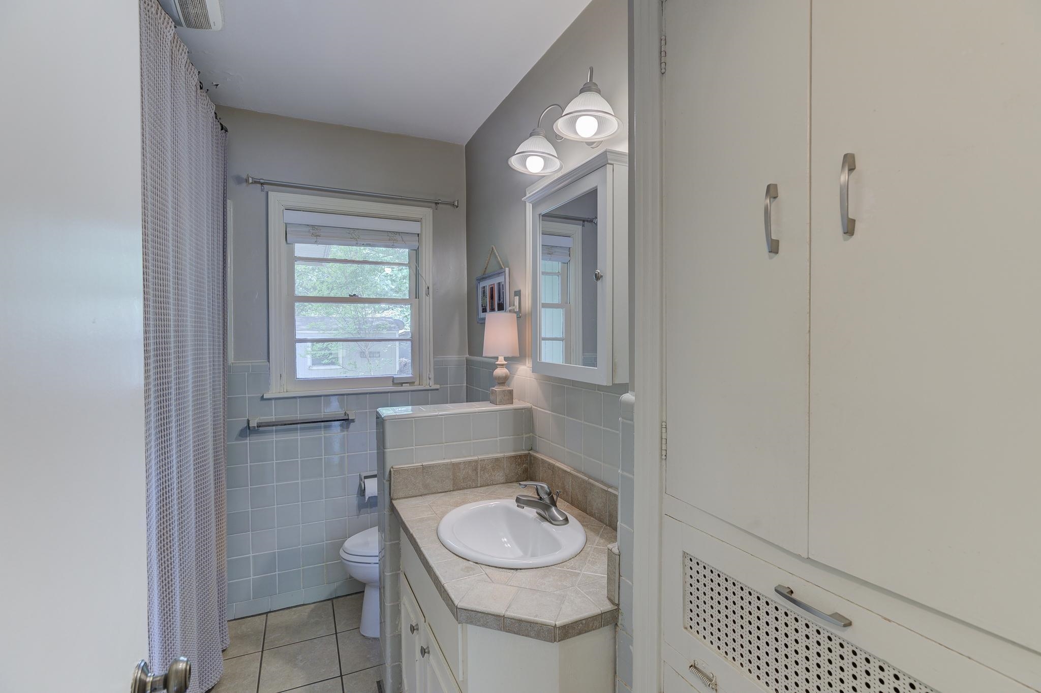 4681 Kaye Road Memphis, TN 38117 - Photo 15 of 25 a bathroom with a granite countertop sink and a mirror