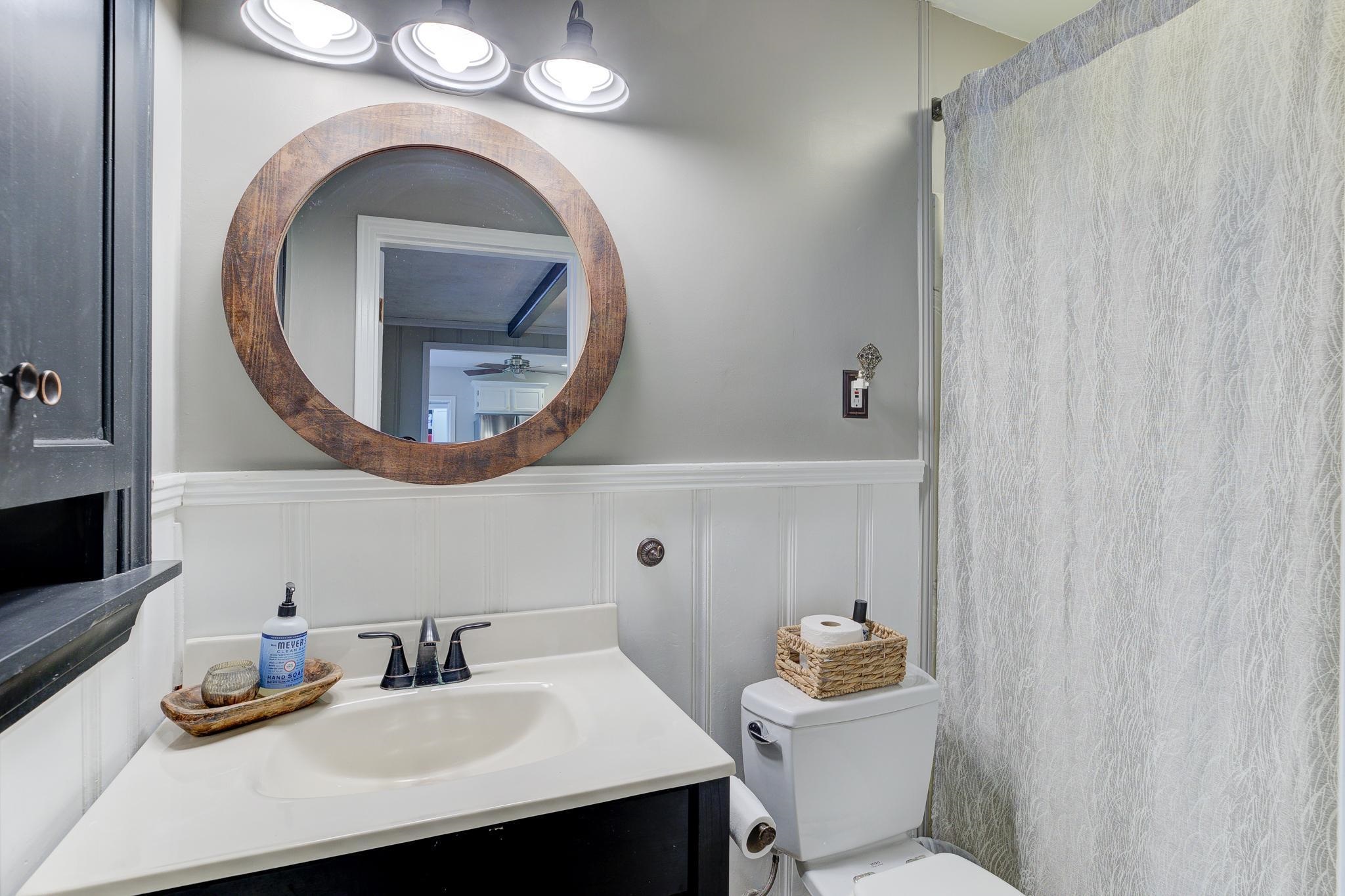 4681 Kaye Road Memphis, TN 38117 - Photo 20 of 25 a bathroom with a sink mirror toilet and vanity