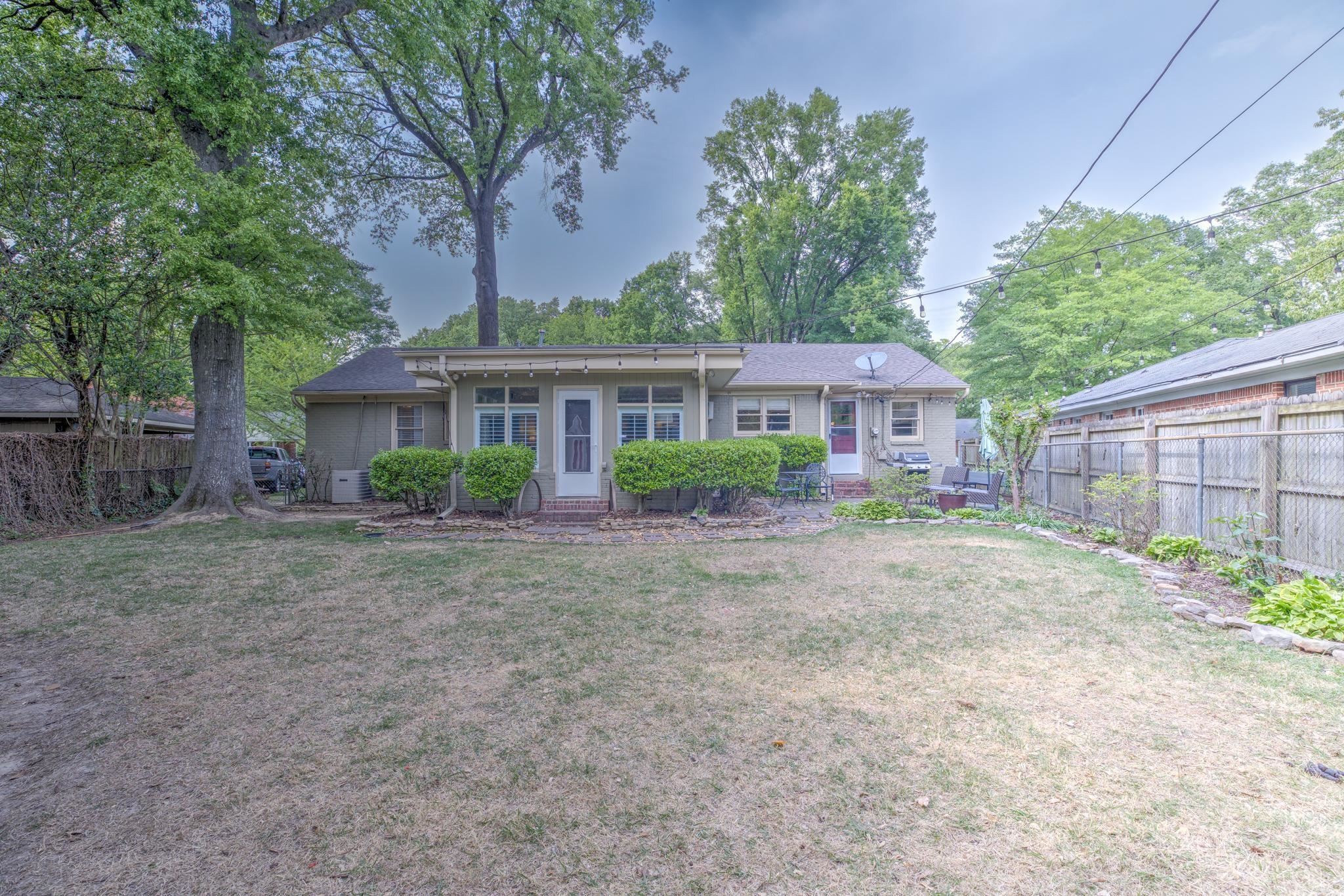 4681 Kaye Road Memphis, TN 38117 - Photo 23 of 25 a front view of a house with a yard and potted plants