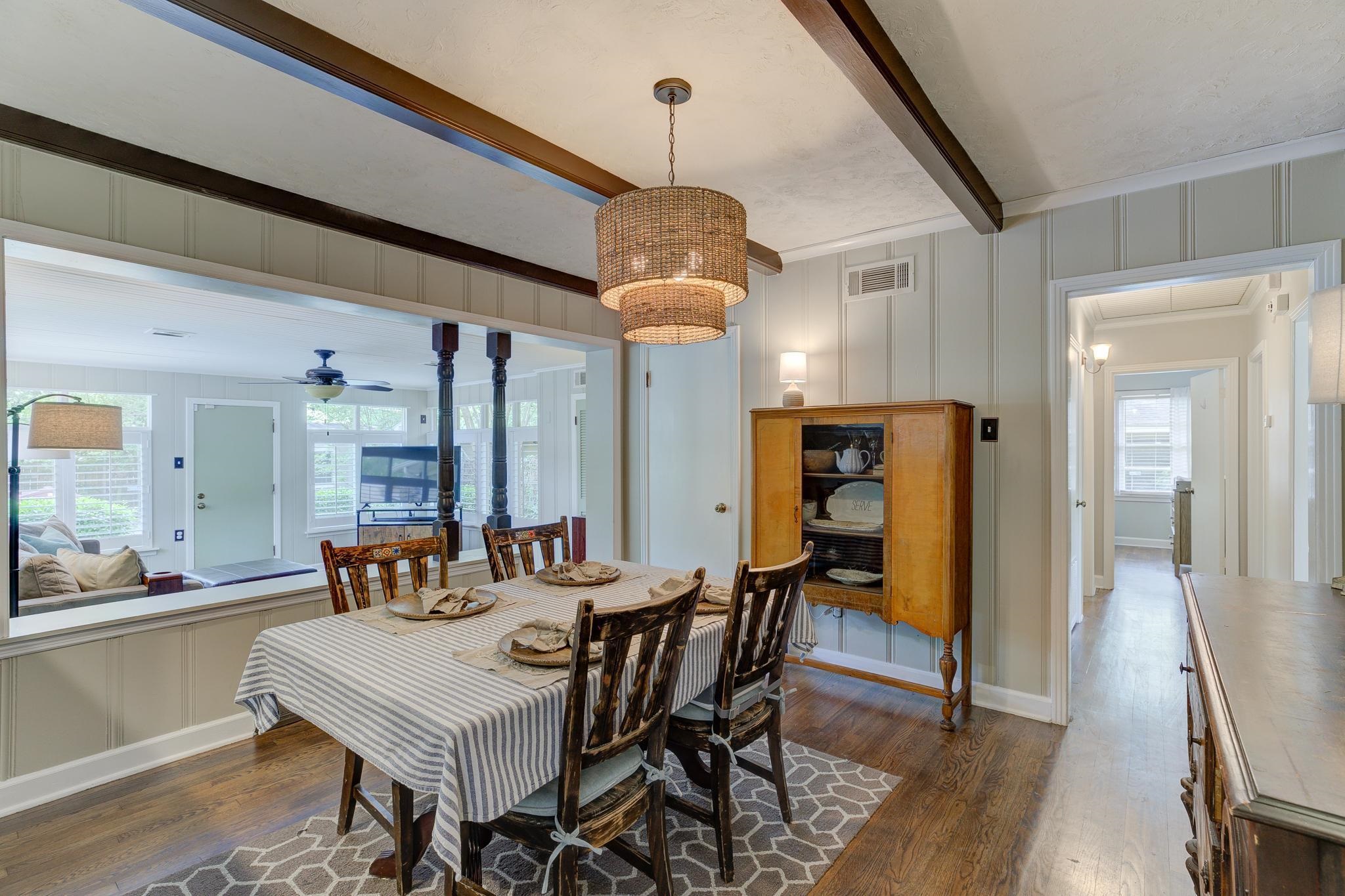 4681 Kaye Road Memphis, TN 38117 - Photo 10 of 25 a dining room with wooden floor a chandelier a wooden table and chairs
