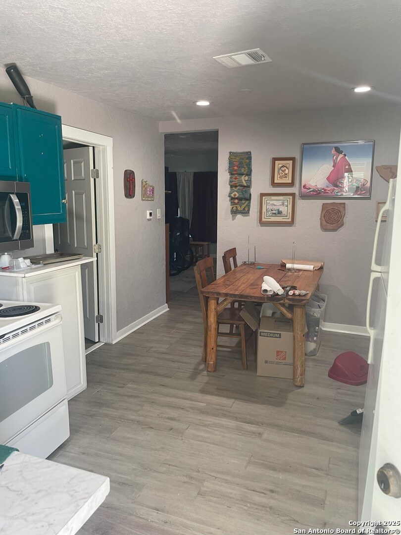 103 South 3rd Street Stockdale, TX 78160 - Photo 15 of 30 a view of a dining room with furniture and wooden floor