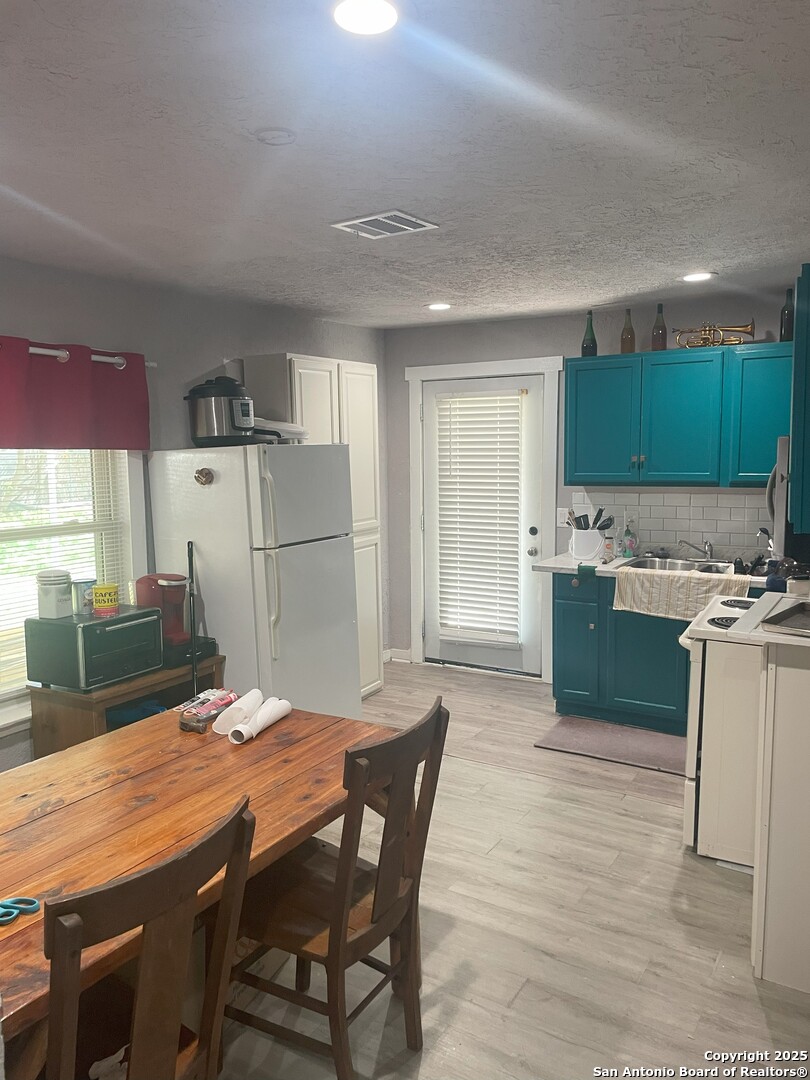 103 South 3rd Street Stockdale, TX 78160 - Photo 16 of 30 a kitchen with kitchen island a sink table and chairs