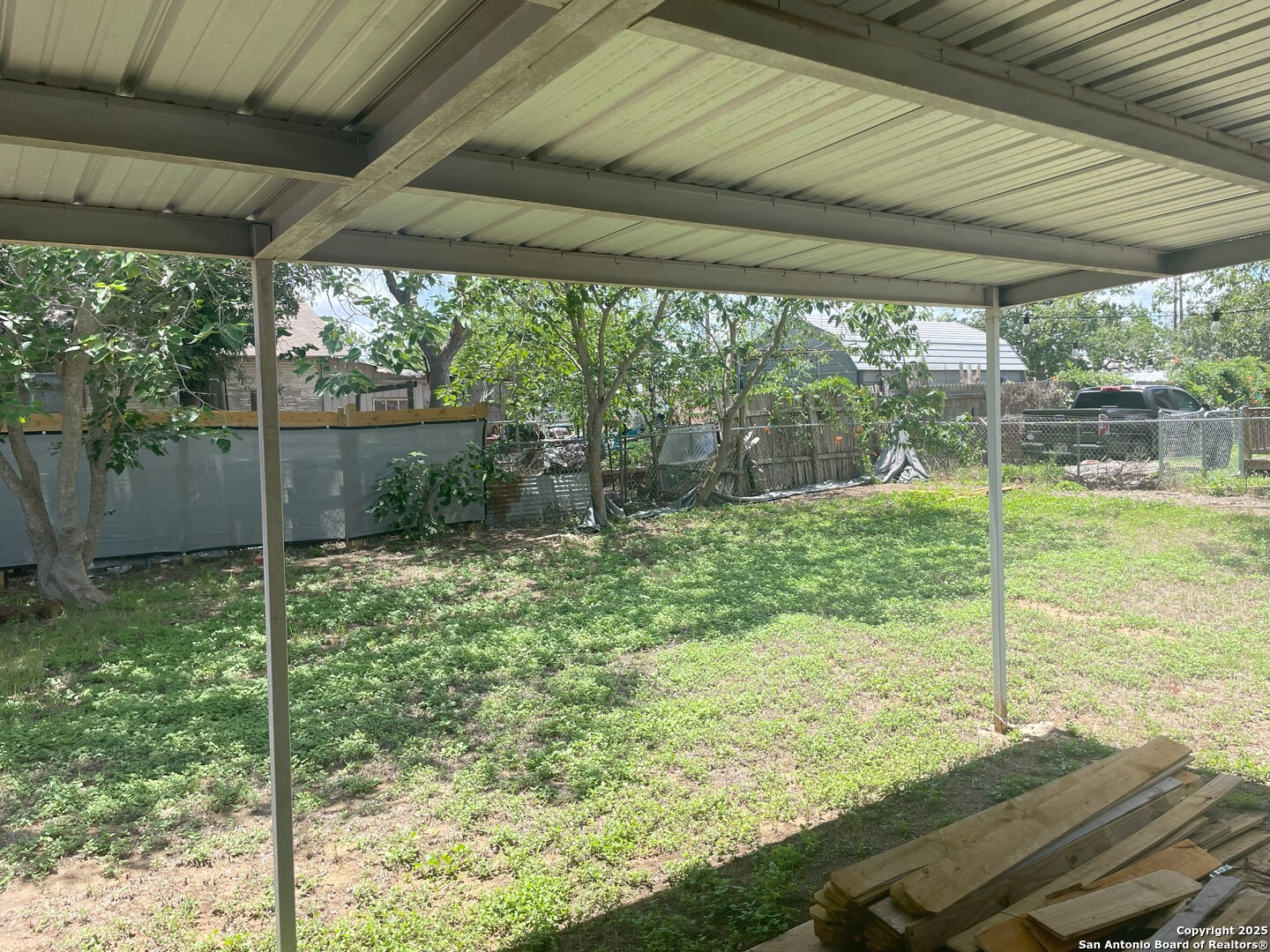103 South 3rd Street Stockdale, TX 78160 - Photo 4 of 30 a view of a backyard with plants and garden