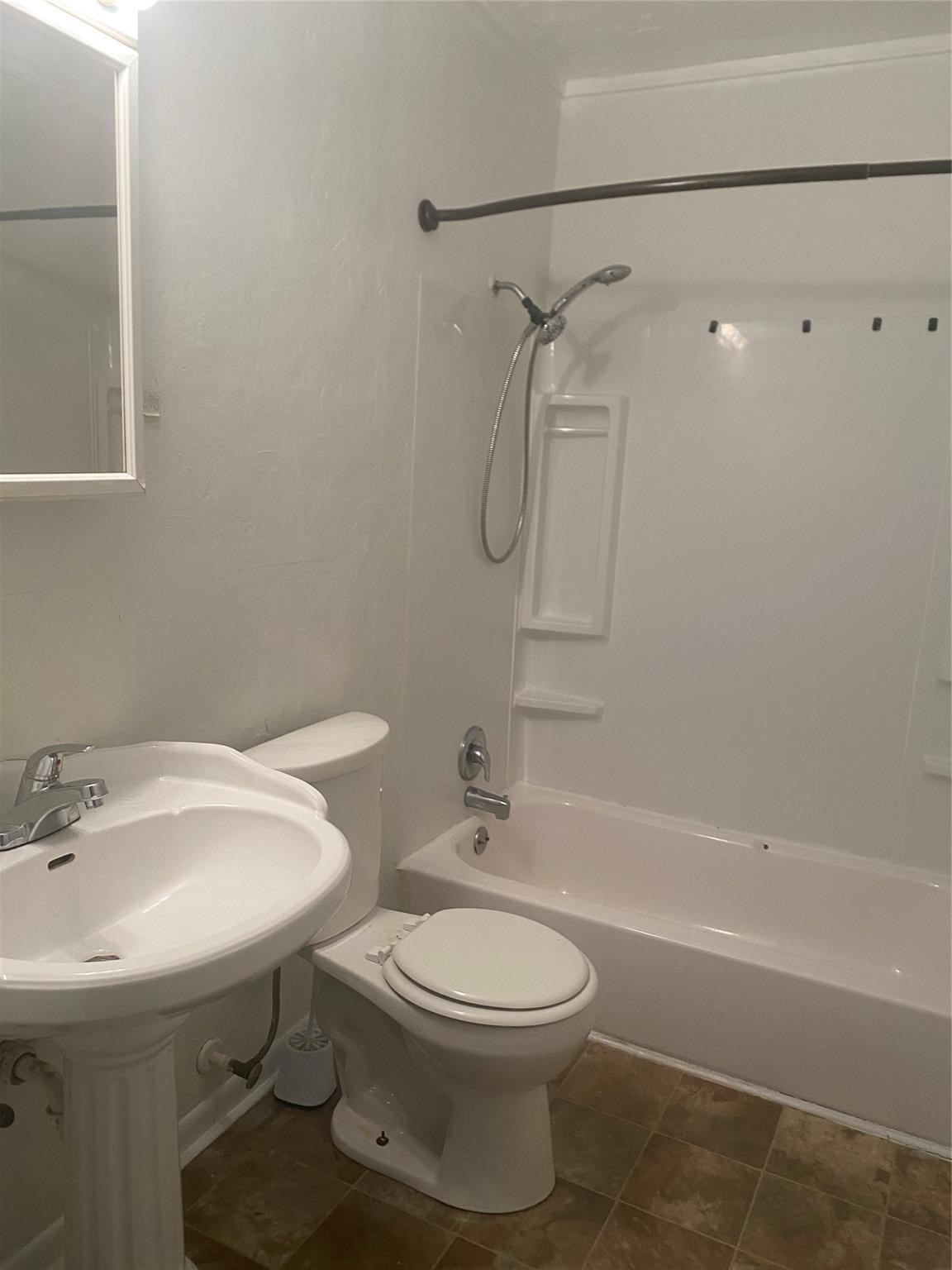 1021 Nottingham Drive Angleton, TX 77515 - Photo 5 of 8 a bathroom with a sink toilet and shower