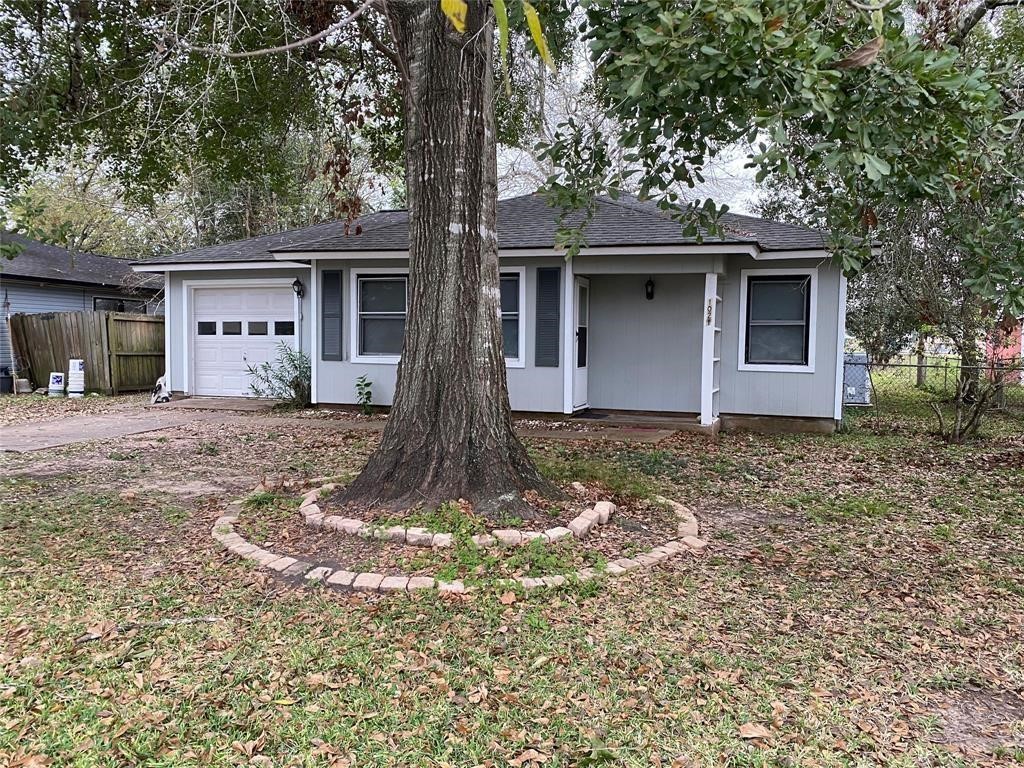 1021 Nottingham Drive Angleton, TX 77515 - Photo 8 of 8 a front view of a house with a yard and garage