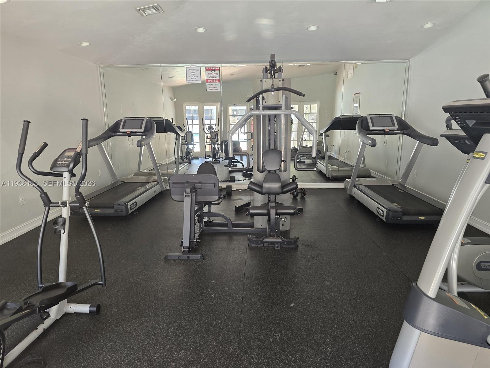 8255 Southwest 152nd Avenue, Unit E207 Miami, FL 33193 - Photo 13 of 14 a view of a room with gym equipment