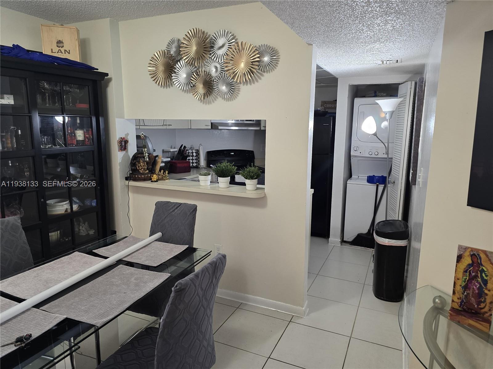 8255 Southwest 152nd Avenue, Unit E207 Miami, FL 33193 - Photo 7 of 14 a view of a dining room with furniture and wooden floor