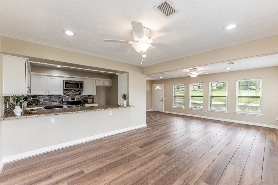 280 Crestmont Point Blank, TX 77364 - Photo 12 of 25 a view of a kitchen with wooden floor and a large window