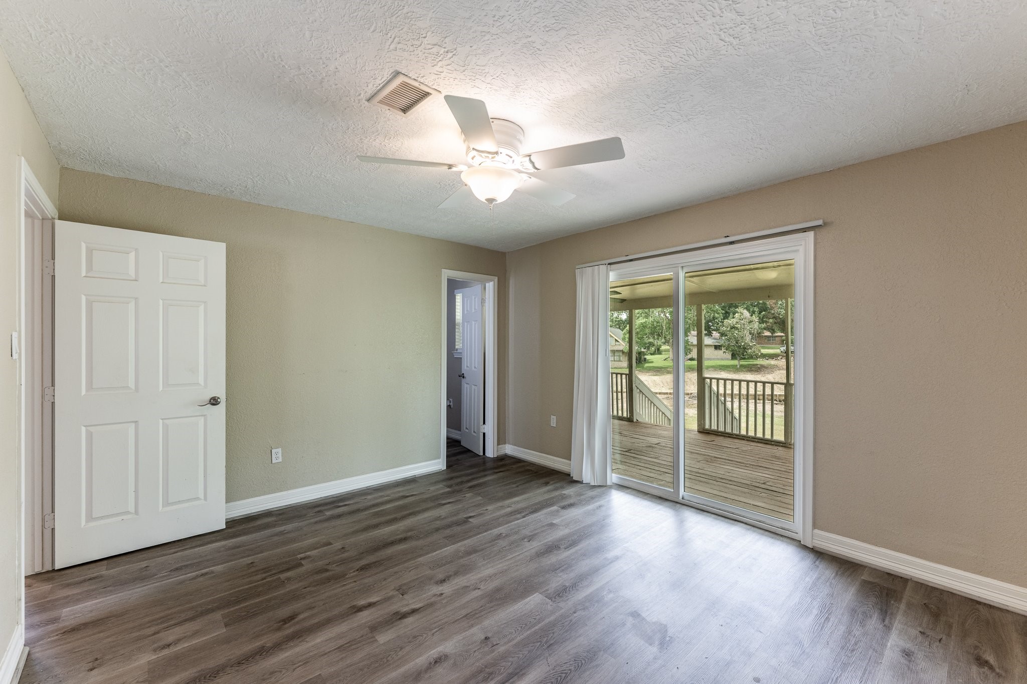280 Crestmont Point Blank, TX 77364 - Photo 14 of 25 an empty room with wooden floor and windows