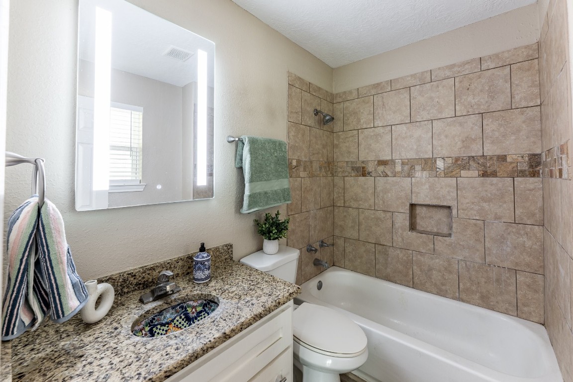 280 Crestmont Point Blank, TX 77364 - Photo 15 of 25 a bathroom with a granite countertop sink a toilet and shower