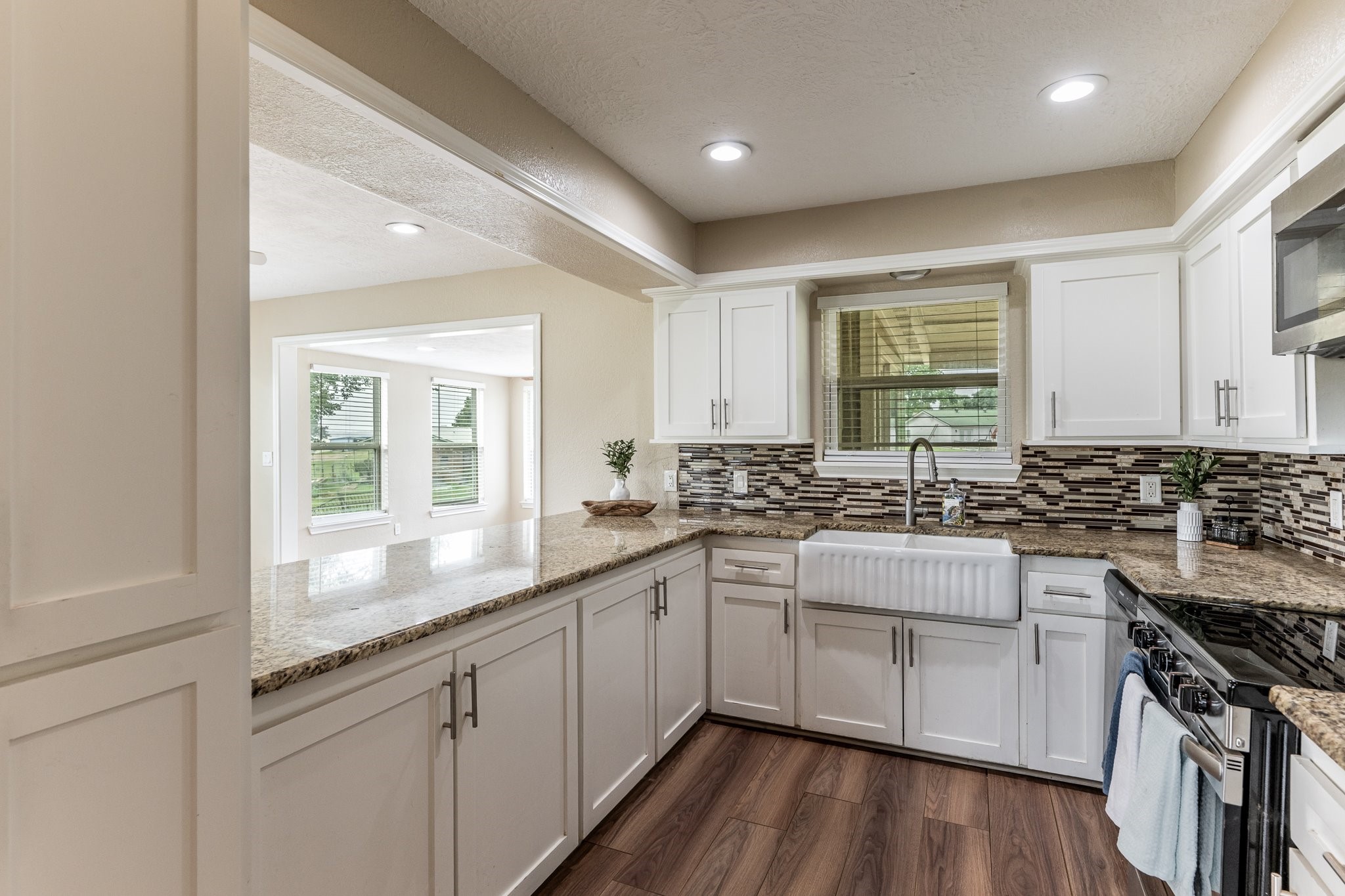 280 Crestmont Point Blank, TX 77364 - Photo 4 of 25 a kitchen with sink stove and cabinets