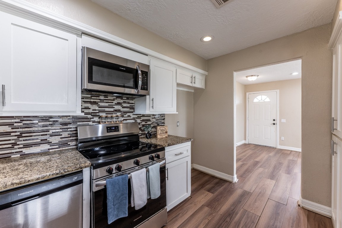 280 Crestmont Point Blank, TX 77364 - Photo 7 of 25 a kitchen with stainless steel appliances granite countertop a stove and a microwave