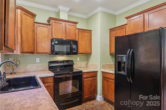 a kitchen with a sink a stove and cabinets