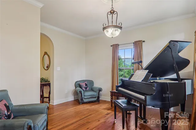 a view of a livingroom with furniture staircase and a chandelier