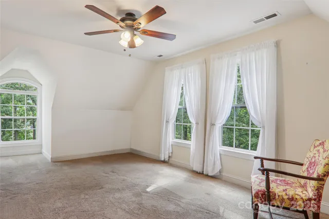 a view of a livingroom with a ceiling fan and a window