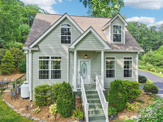 a view of a house with wooden walls and potted plants
