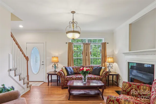 a living room with furniture a fireplace and a large window