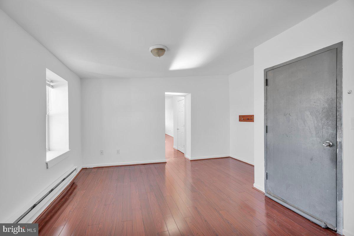 3151 Richmond Street, Unit 3 Philadelphia, PA 19134 - Photo 12 of 22 an empty room with wooden floor and windows