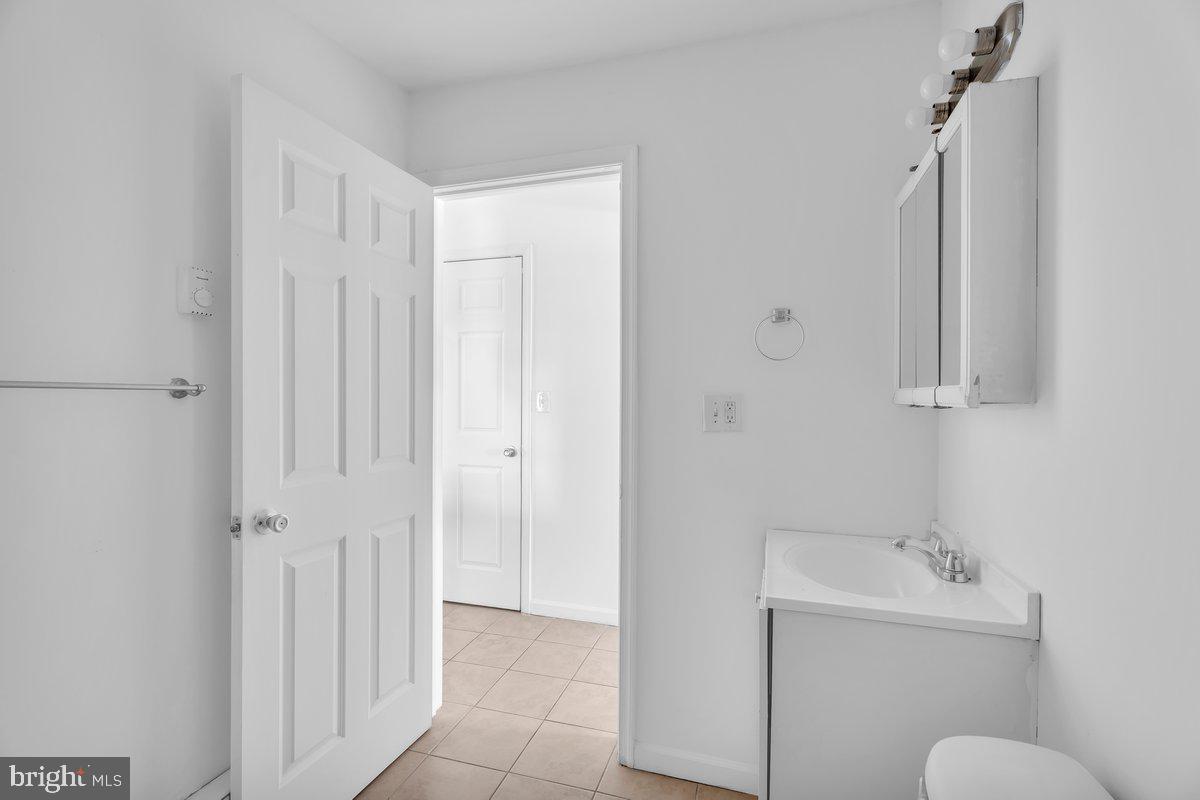 3151 Richmond Street, Unit 3 Philadelphia, PA 19134 - Photo 21 of 22 a bathroom with a sink a toilet and shower