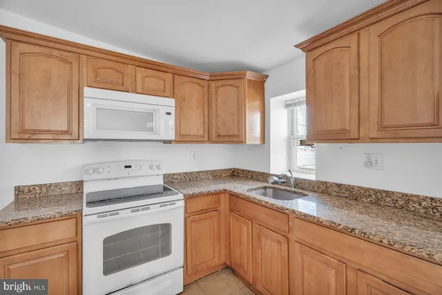 a kitchen with appliances cabinets and a counter top space