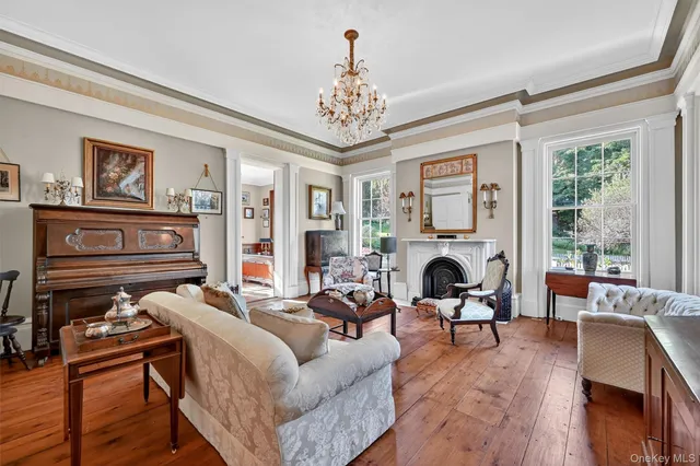 a living room with furniture large window and fireplace