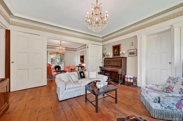a living room with furniture and a chandelier