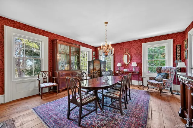 a dining room with furniture window and wooden floor