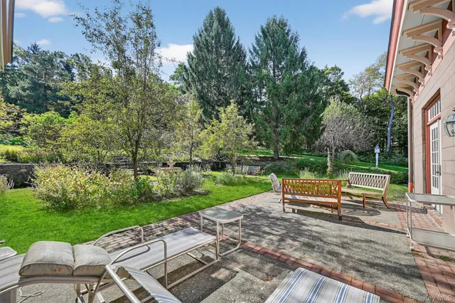 a view of park with bench in front of house