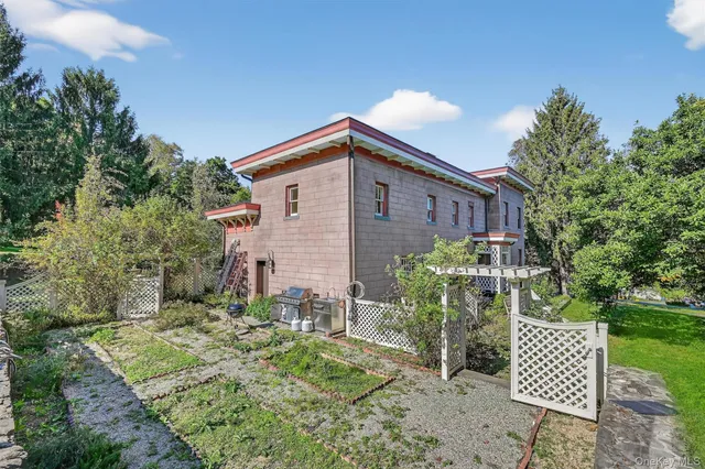 a view of a backyard with plants and a garden