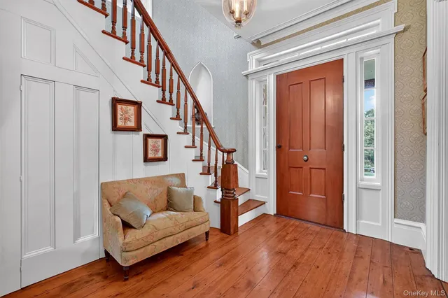 a view of entryway livingroom and hall with wooden floor