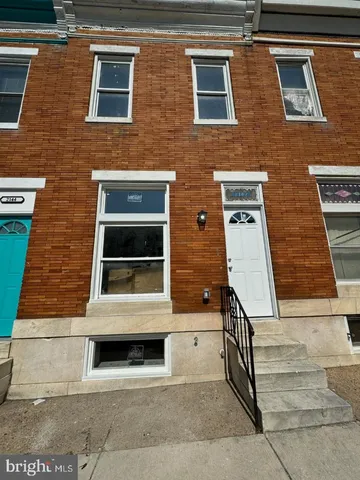 a view of a brick house with many windows