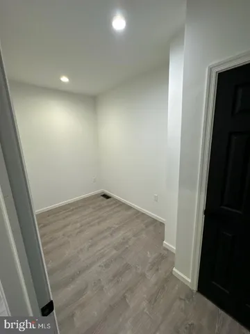 an empty room with wooden floor