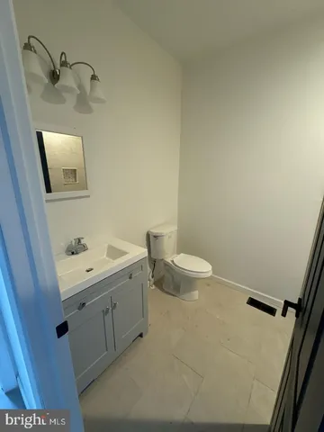 a bathroom with a sink a toilet and mirror