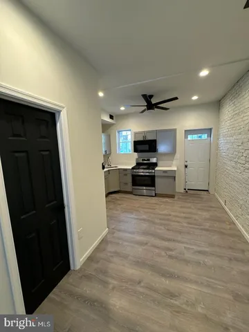 a view of kitchen with refrigerator stove and cabinets