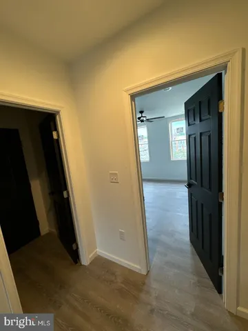 a view of hallway with wooden floor and stairs