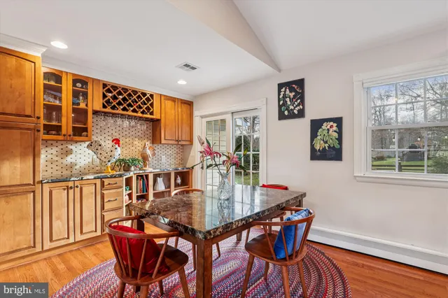 a view of a dining room with furniture and a window