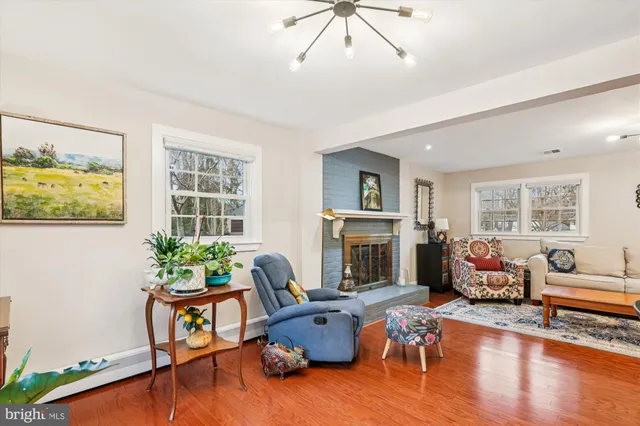 a living room with furniture fireplace and window