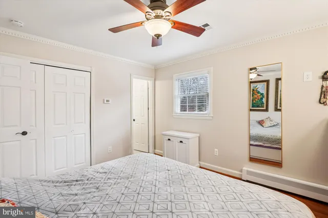 a view of a bedroom with closet and window