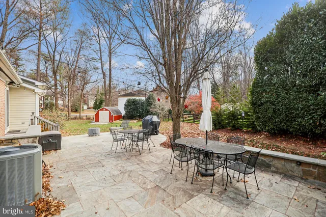 a white kitchen with a sink and a large window