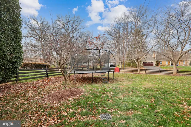 a view of a patio with table and chairs and wooden fence