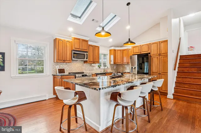 a view of a dining room with furniture a chandelier and wooden floor