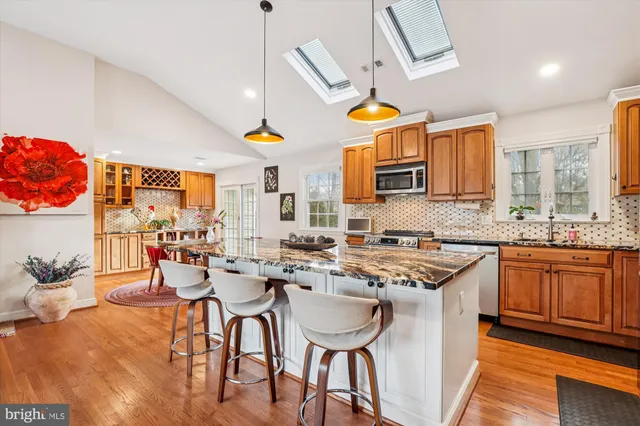 a kitchen with stainless steel appliances granite countertop a sink and cabinets