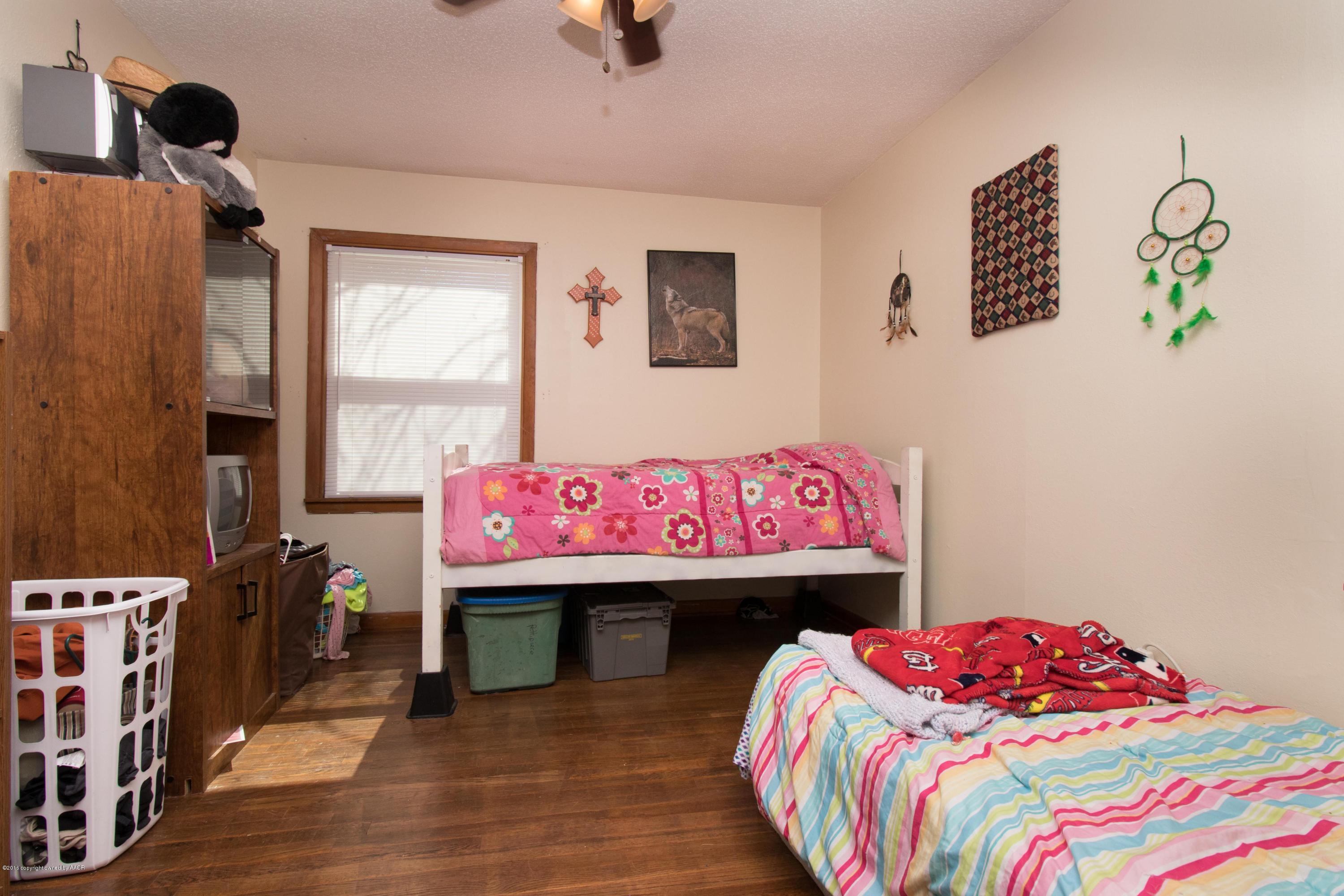 4309 South Monroe Street Amarillo, TX 79110 - Photo 12 of 16 a bedroom with a bed and a window