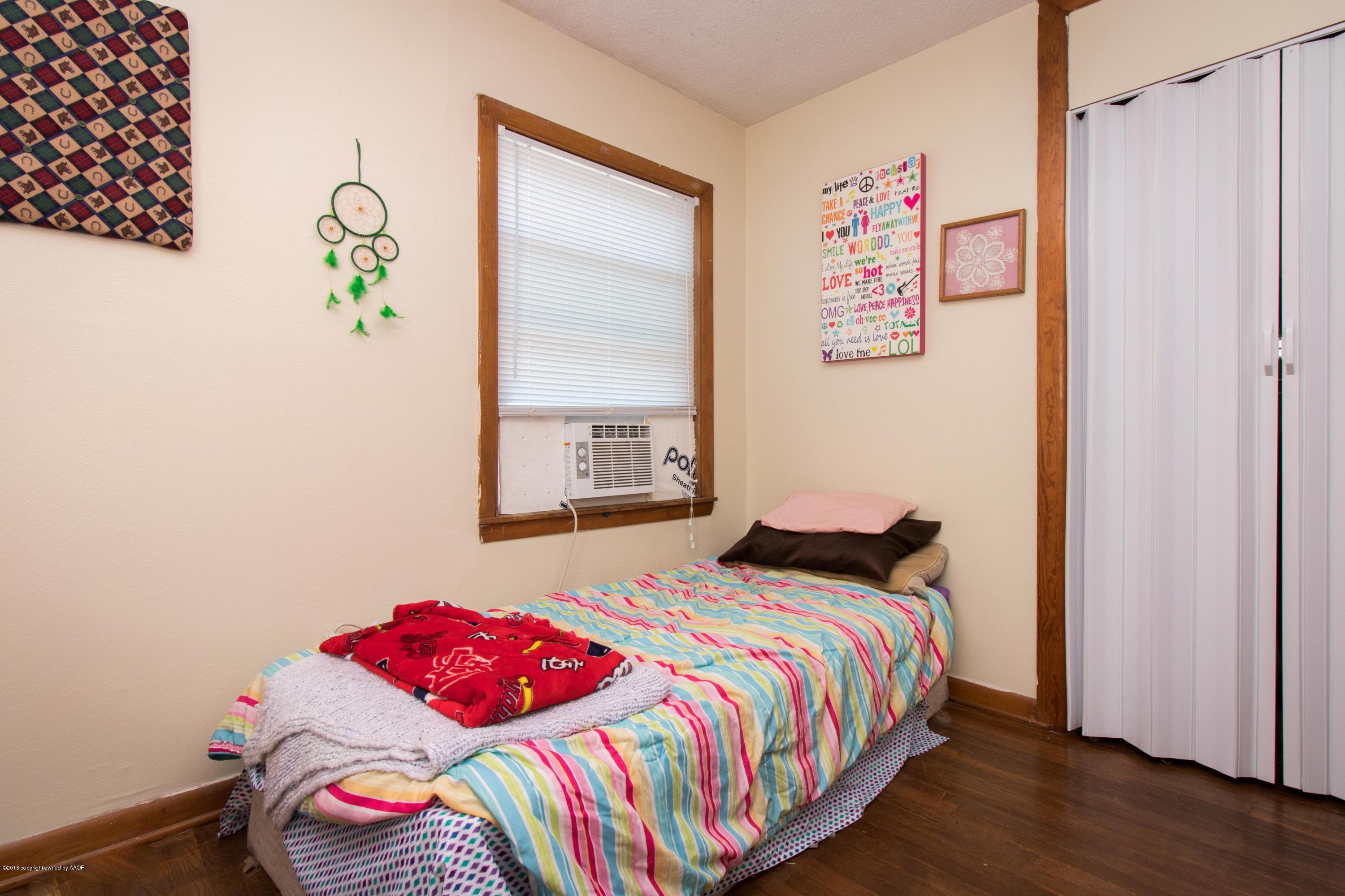 4309 South Monroe Street Amarillo, TX 79110 - Photo 14 of 16 a bedroom with a bed and a window