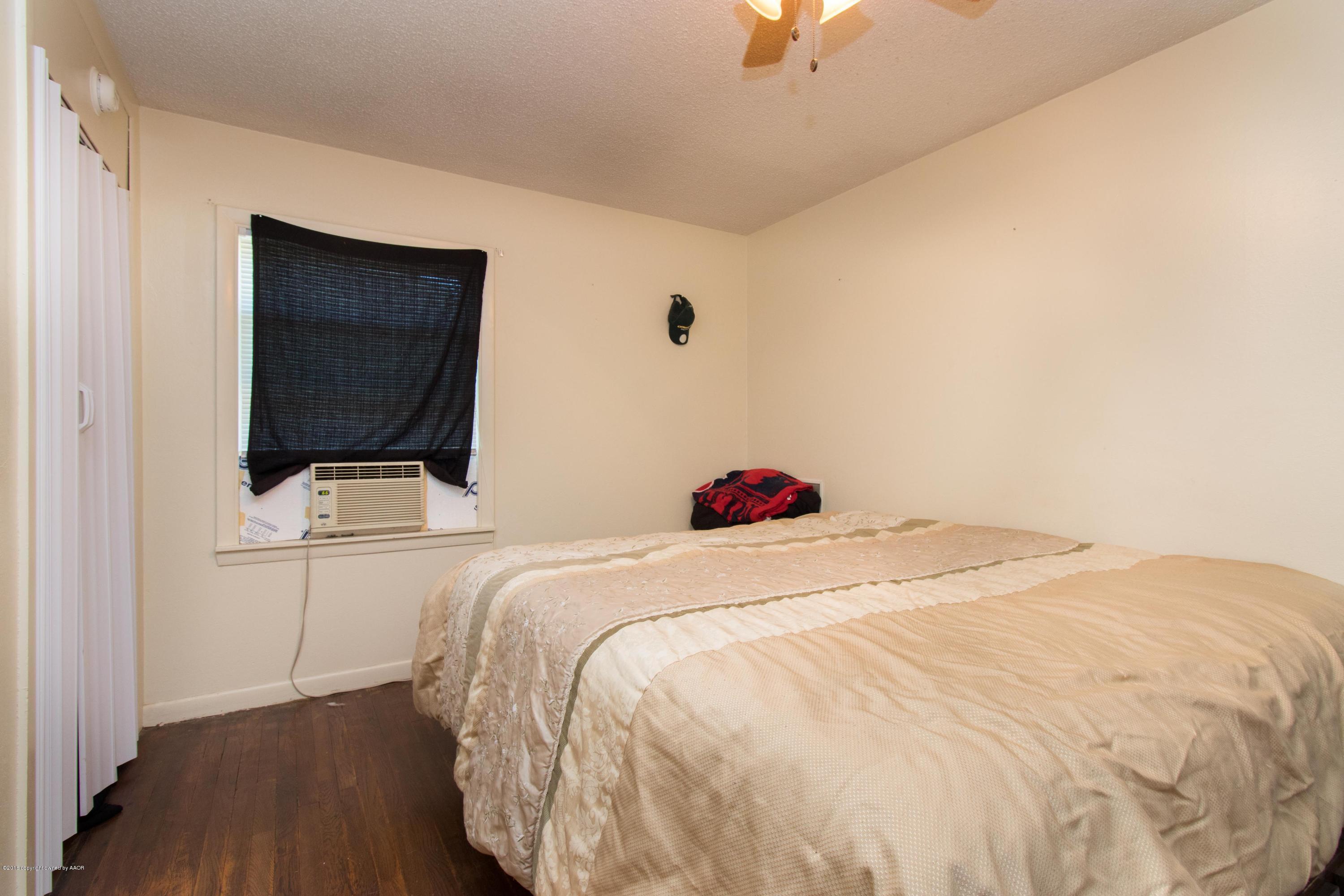4309 South Monroe Street Amarillo, TX 79110 - Photo 15 of 16 a bedroom with a bed and a flat screen tv